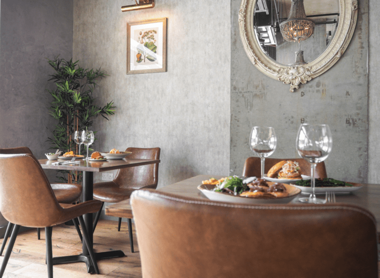 Restaurant tables and chairs laid up for service