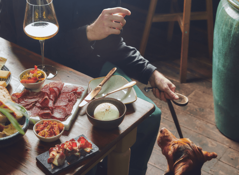 Man feeding dog from the table