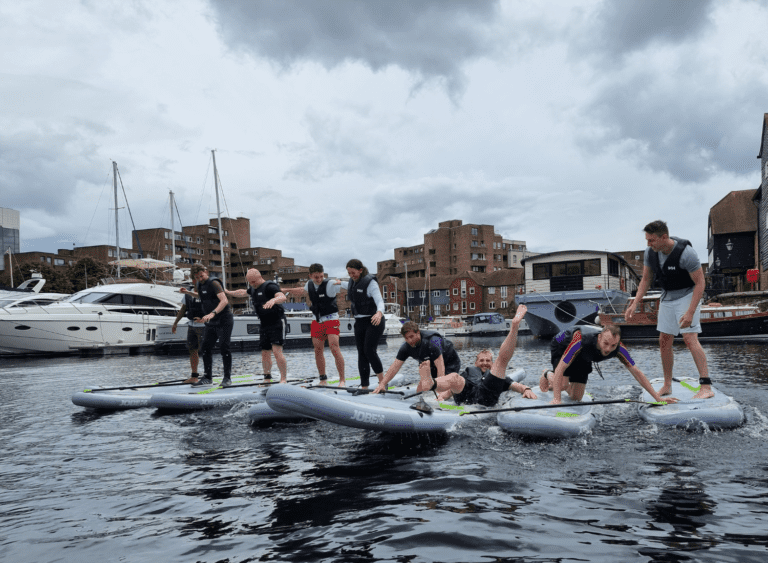 People standing on paddleboards