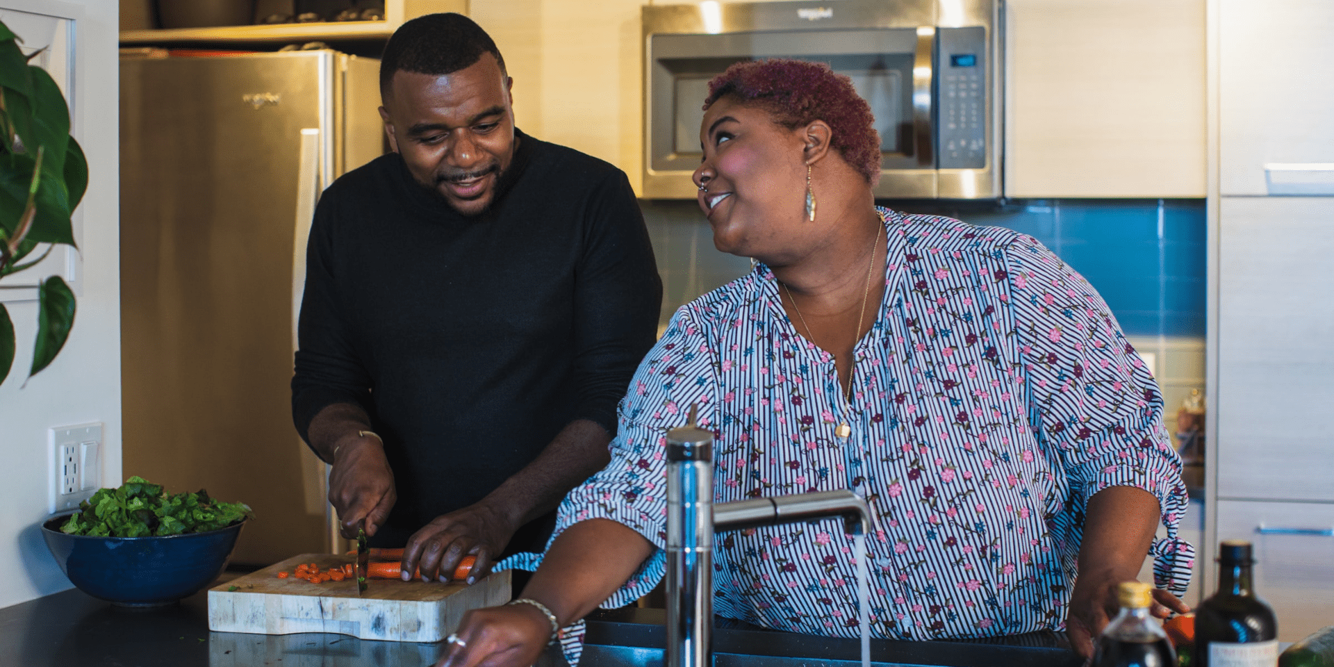 Two people preparing food in the kitchen