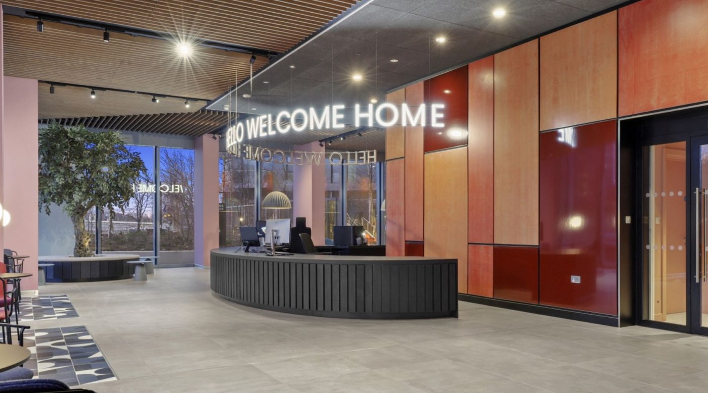 Lobby of Portlands Place in East Village with an LED sign that says 'Welcome Home'