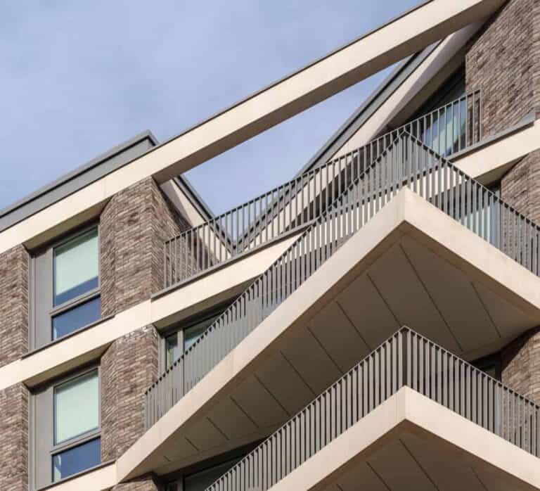 Upward shot of the top of an East Village building showing angled balconies