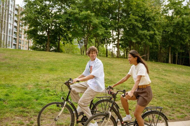 Couple cycling through East Village neighbourhood